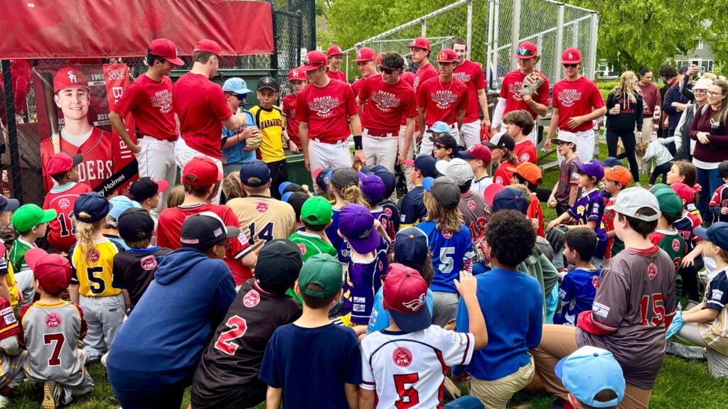 Shaker Heights High School baseball players with Shaker Youth Baseball Players