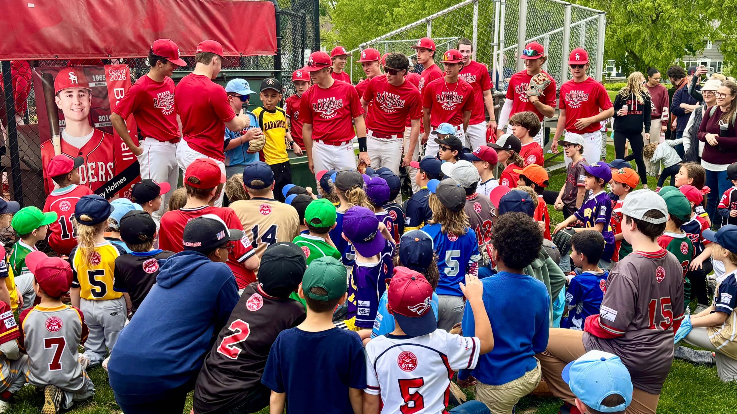 Shaker Heights High School baseball players with Shaker Youth Baseball Players
