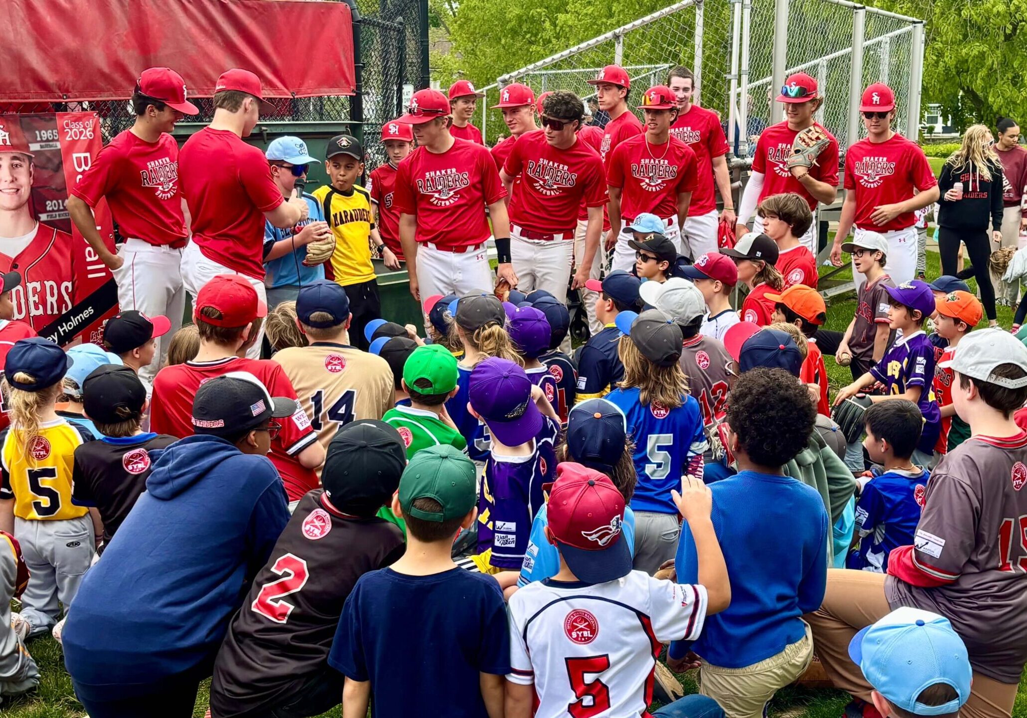 Shaker Heights High School baseball players with Shaker Youth Baseball Players